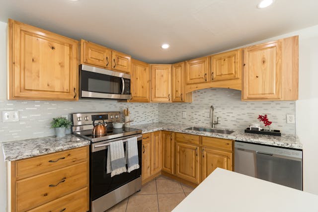 home kitchen with light wooden cabinets
